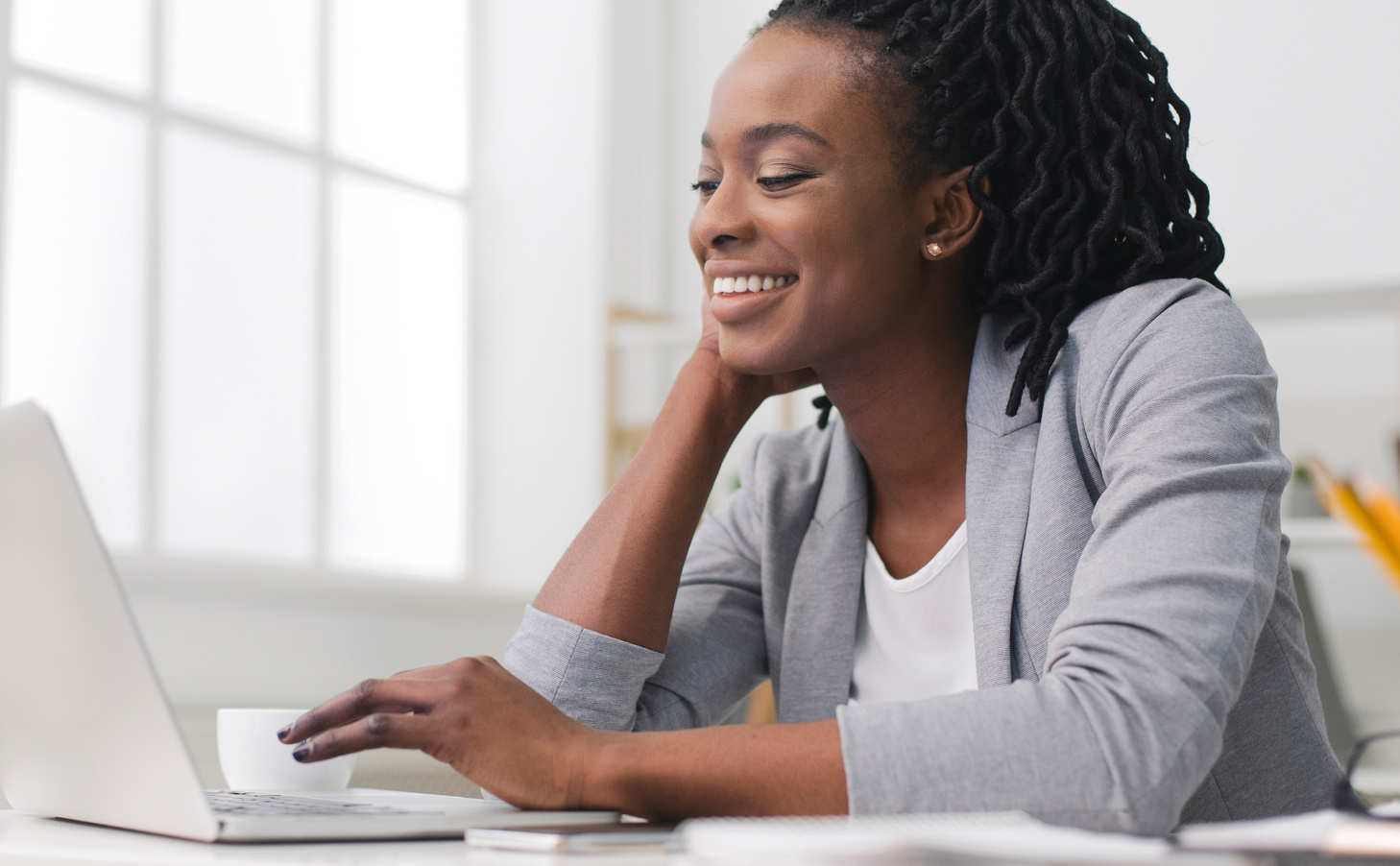 Successful Black Business Lady Typing On Laptop In Office
